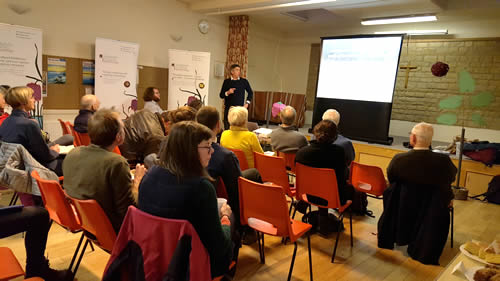 Male academic gives a public talk to an audience