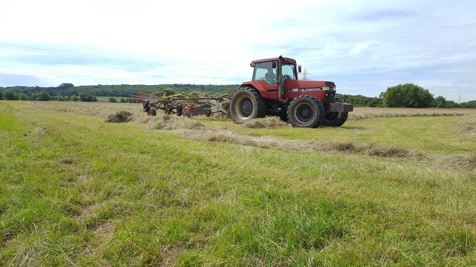 A tractor working in a floodplain meadow.