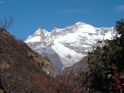Snow capped mountain in background with lower hills in foreground