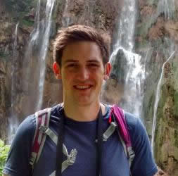 Bertie Welch - a man stands in front of a waterfall