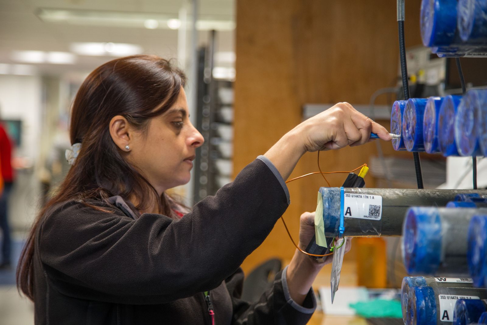 Professor Pallavi Anand, taking measurements in a laboratory.