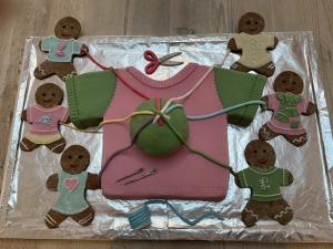 Cake with icing clothes and mending gingerbread people