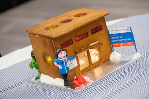 gingerbread hospital with an icing nurse and woman in labour outside