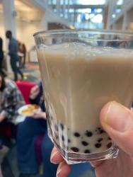 hand holding a glass of boba tea