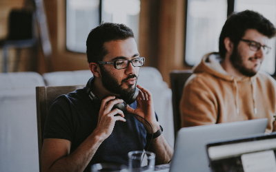 Person working at a computer and putting on a headset