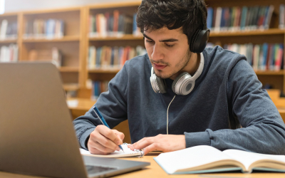 Student studying on a laptop and wearing headphones