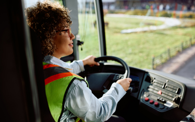 A person driving a bus
