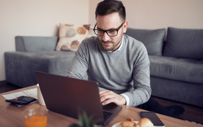 Man studying a laptop on a coffee table