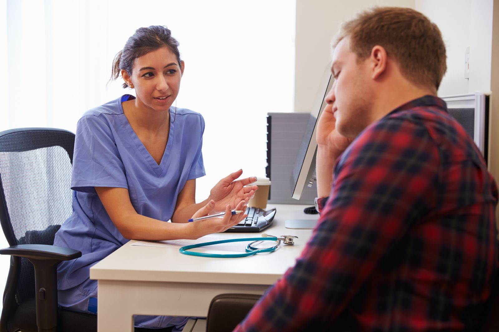 A nurse having a conversation with a patient