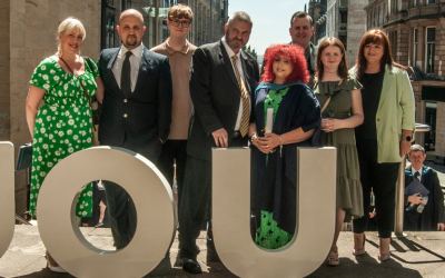 Helen with family around OU sign